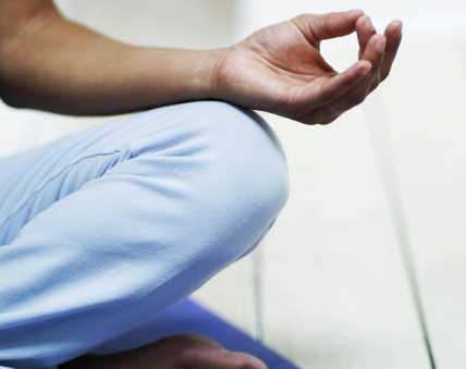 Young Woman Meditating on the Floor